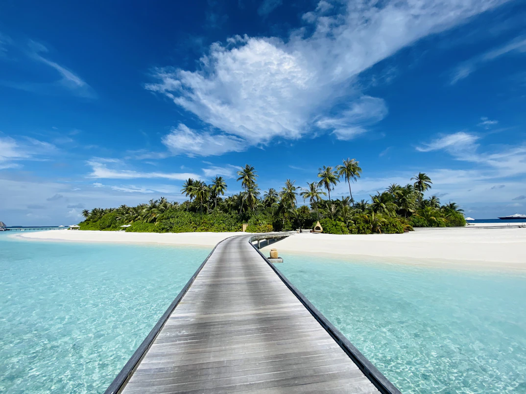 Ponton en bois menant à une île tropicale